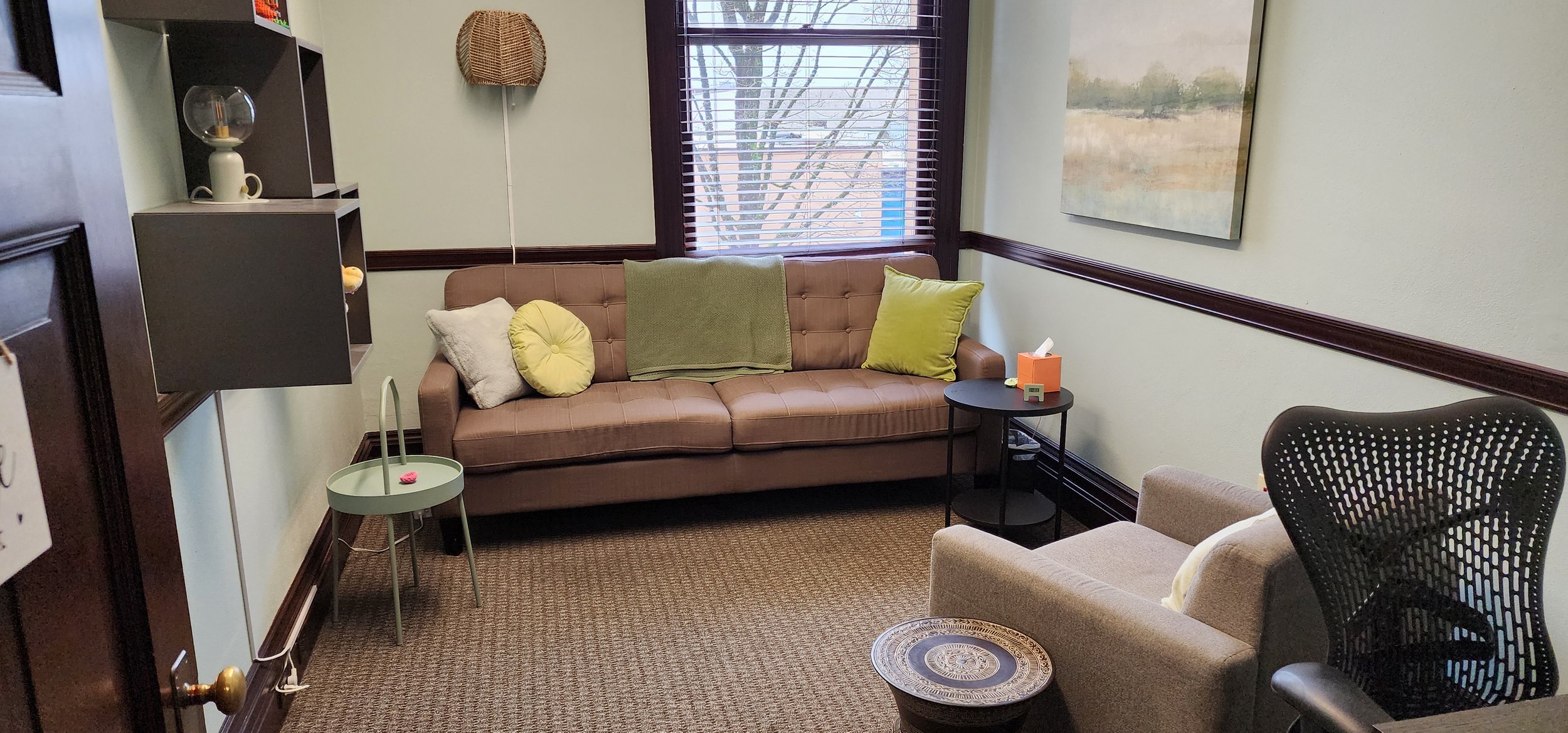 Therapy office with chair, sofa, and window